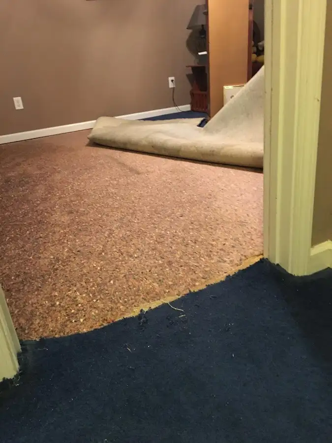 Carpet pad removal revealing water damage during Drying & Dehumidification in Glenpool